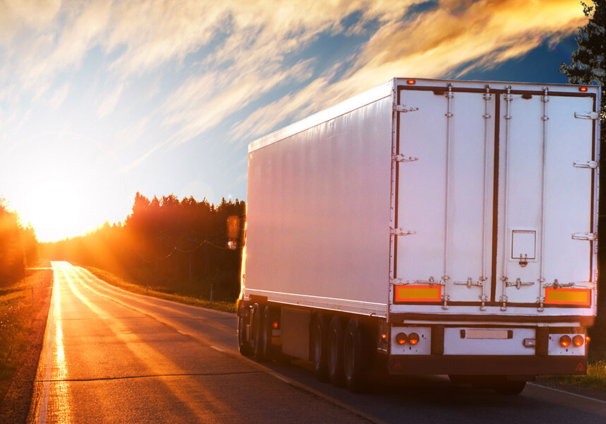 White truck on the asphalt road in the evening